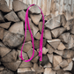 Berry Pink multi-way hands-free BioThane dog lead with a heavy-duty black lockable carabiner and O-ring placed on a wooden stack